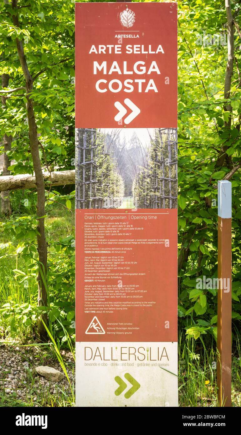 Sign indicating mountain routes and touristic information in the Arte Natura route - Arte Sella - the park with many artworks - Borgo Valsugna -Italy Stock Photo