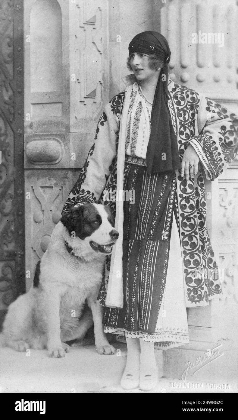 Most Popular Woman in Romania The beautiful Vrown Princess photgraphed with her favourite dog . She is seen wearing a wonderfully worked coat of peasant manufacture 20 December 1923 Stock Photo