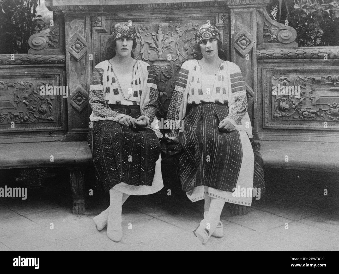 Charming Royal Sisters in National Costume Princess Irene of Greece who recently celebrated her 19 birthday , is seen here in Roumanian national costume with her eldest sister Princess Helene , now Crown Princess of ROumania . Princess Irene is on the left . SHe is engaged to marry the dDuke of Apulia and it is said will spend part of her honeymoon in London Harrogate 5 April 1923 Stock Photo