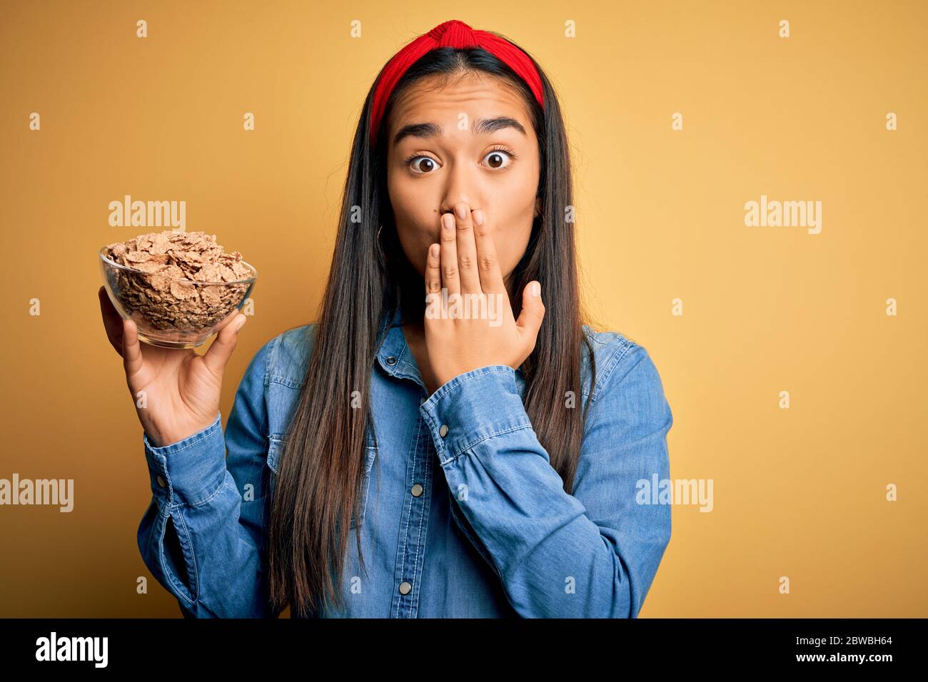 Beautiful asian woman holding bowl with healthy corn flakes cereals