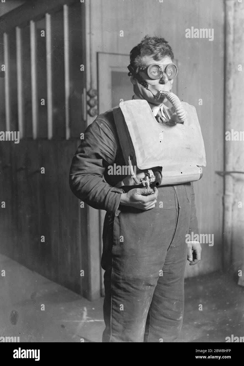 Mr R H Davis , managing director of Siebe , Gohman and Co , with the new apparatus which renders escape from sunken submarines possible in 40 seconds . Fitted with oxygen tubes , it can be used as a first aid appliance . 14 November 1929 Stock Photo