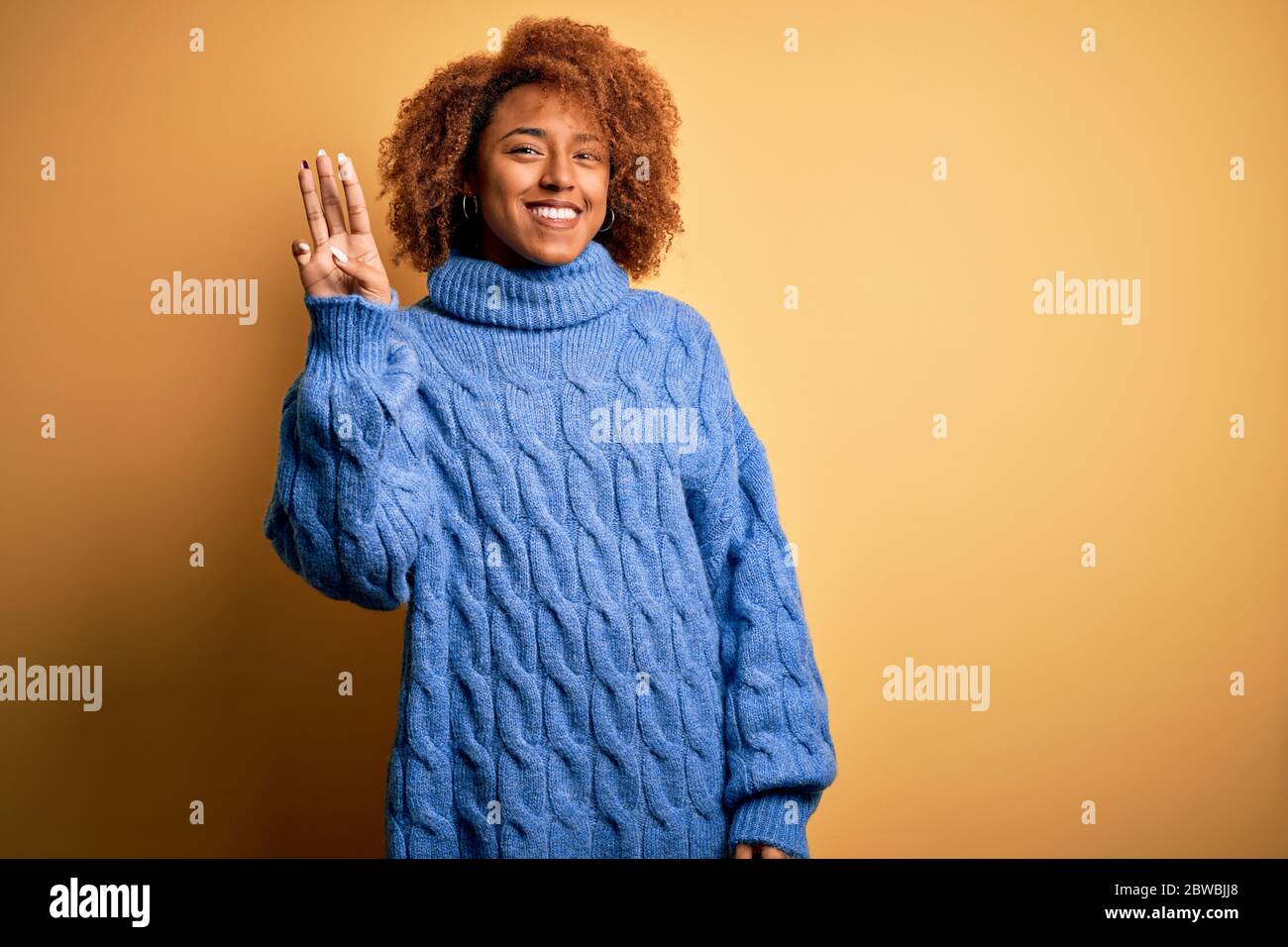 Young beautiful African American afro woman with curly hair wearing ...