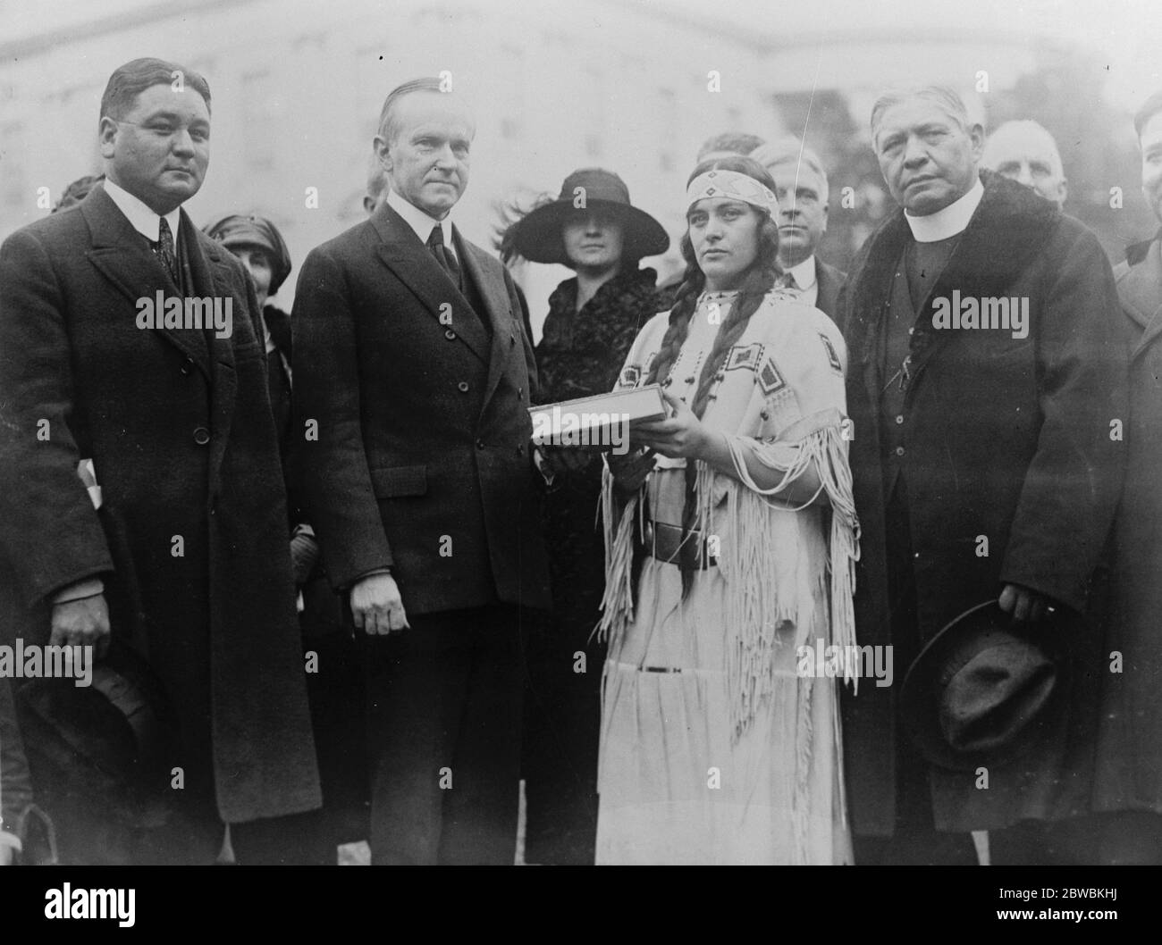 Indian girl goes to White House in costume with plea for people . An appeal for government help through more schools in leading the Indians of America  back to their rightful heritage of greatness and nobility  was presented to President Coolidge with such force and clarity by Miss Ruth Muskrat , a Cherokes Indian girl , now a student at Mount Holyoke College , that the Chief Executive invited her to take lunch with him and Mrs Coolidge . Left to right : Dr Roe Cloud ; President Coolidge ; Miss Muskrat , Sherman Coolidge and Dr Charles Eastman . 22 December 1923 Stock Photo