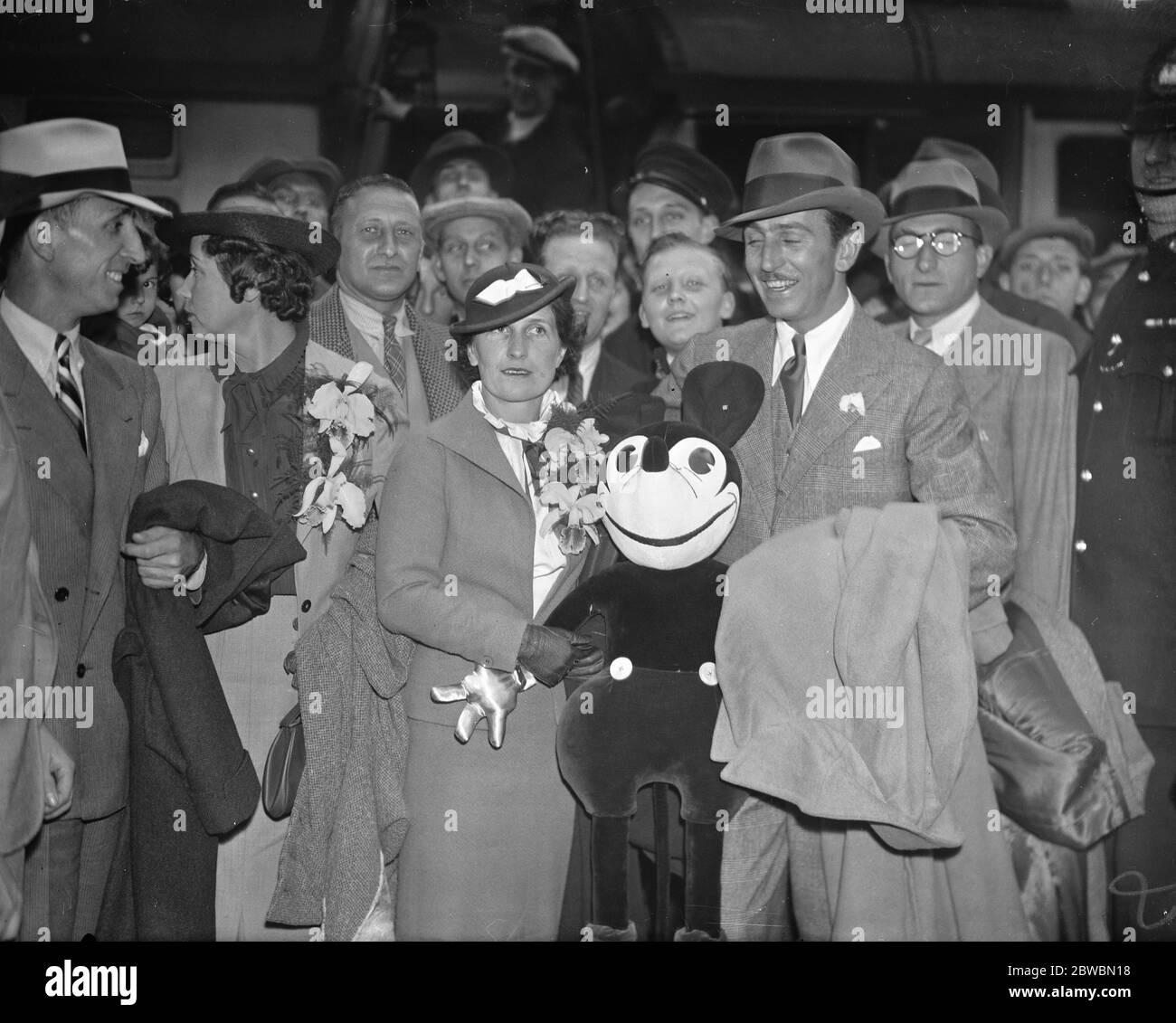 Walt Disney ( creator of ' Mickey Mouse ' ) and mrs Disney on their arrival from America 12 June 1935 Stock Photo