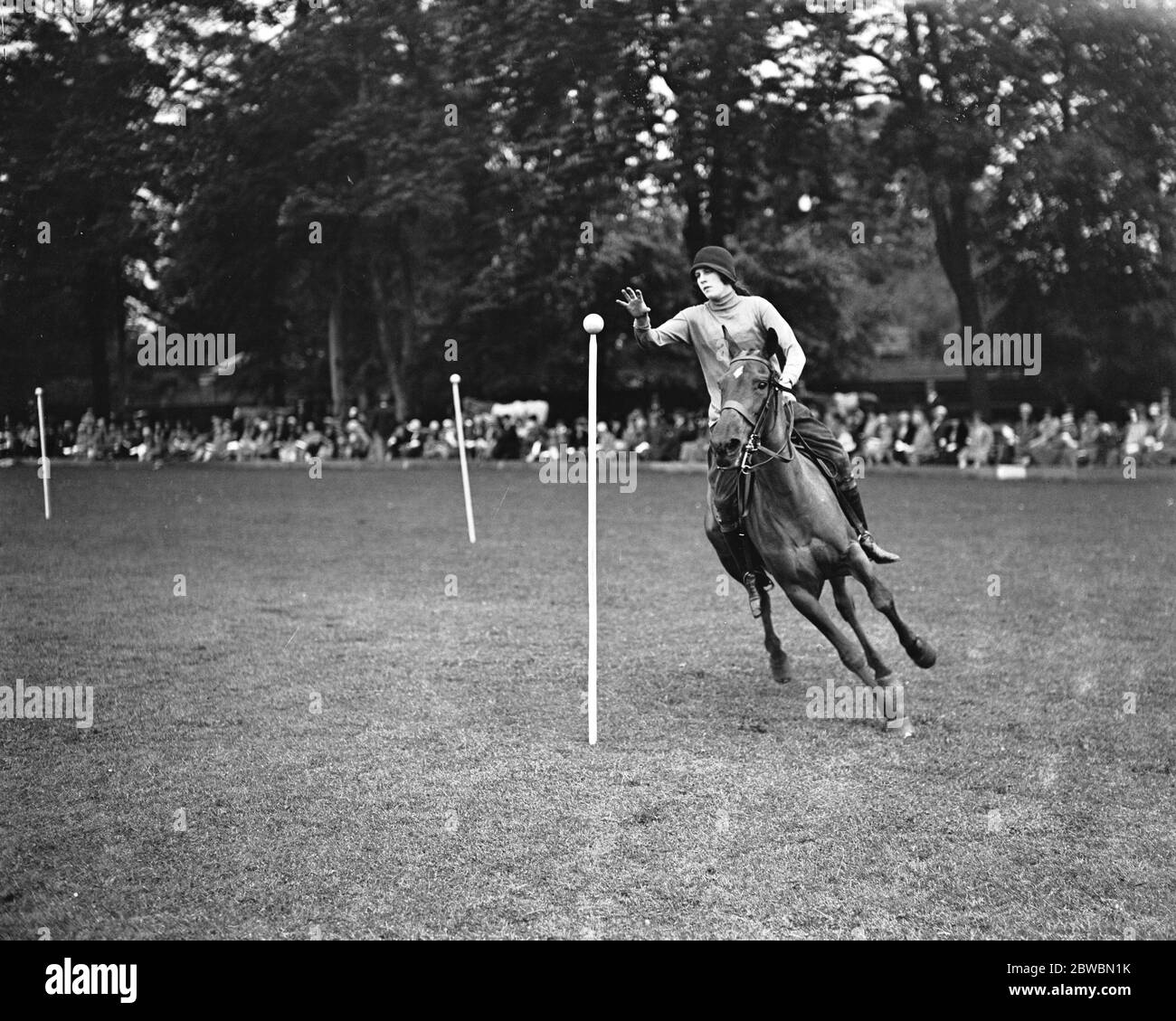 Roehampton Club Pony Gymkhana Miss Cecilie Nickalls taking a ball from the post in the ball and basket race 28 May 1920, Stock Photo