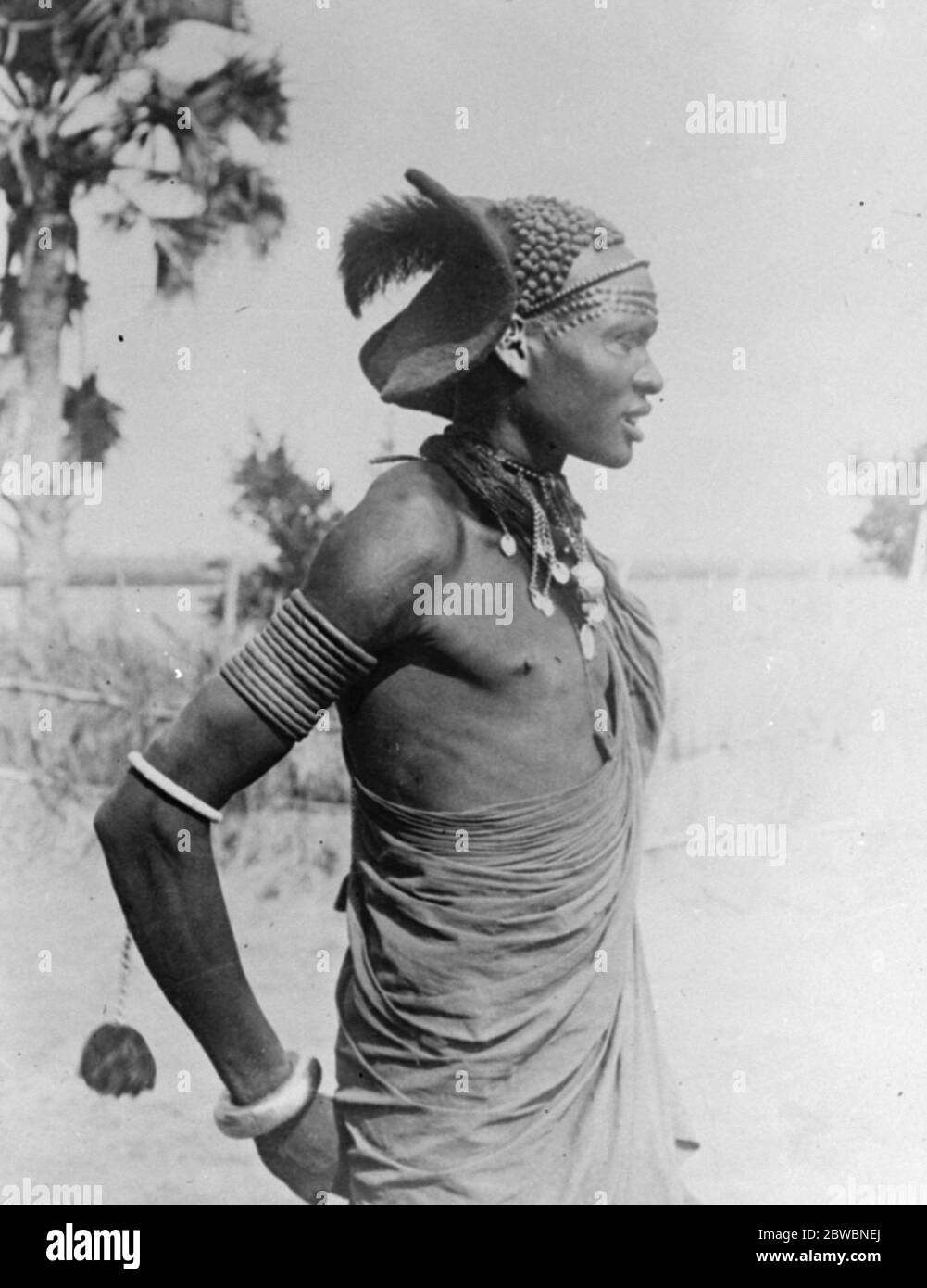 Mud coffure for a Sudan native Dandy . A Shilluk native in the Sudan photographed after dressing his hair in a remarkable fashion . The hair has been made up into dainty little balls with the aid of mud . 30 March 1923 Stock Photo