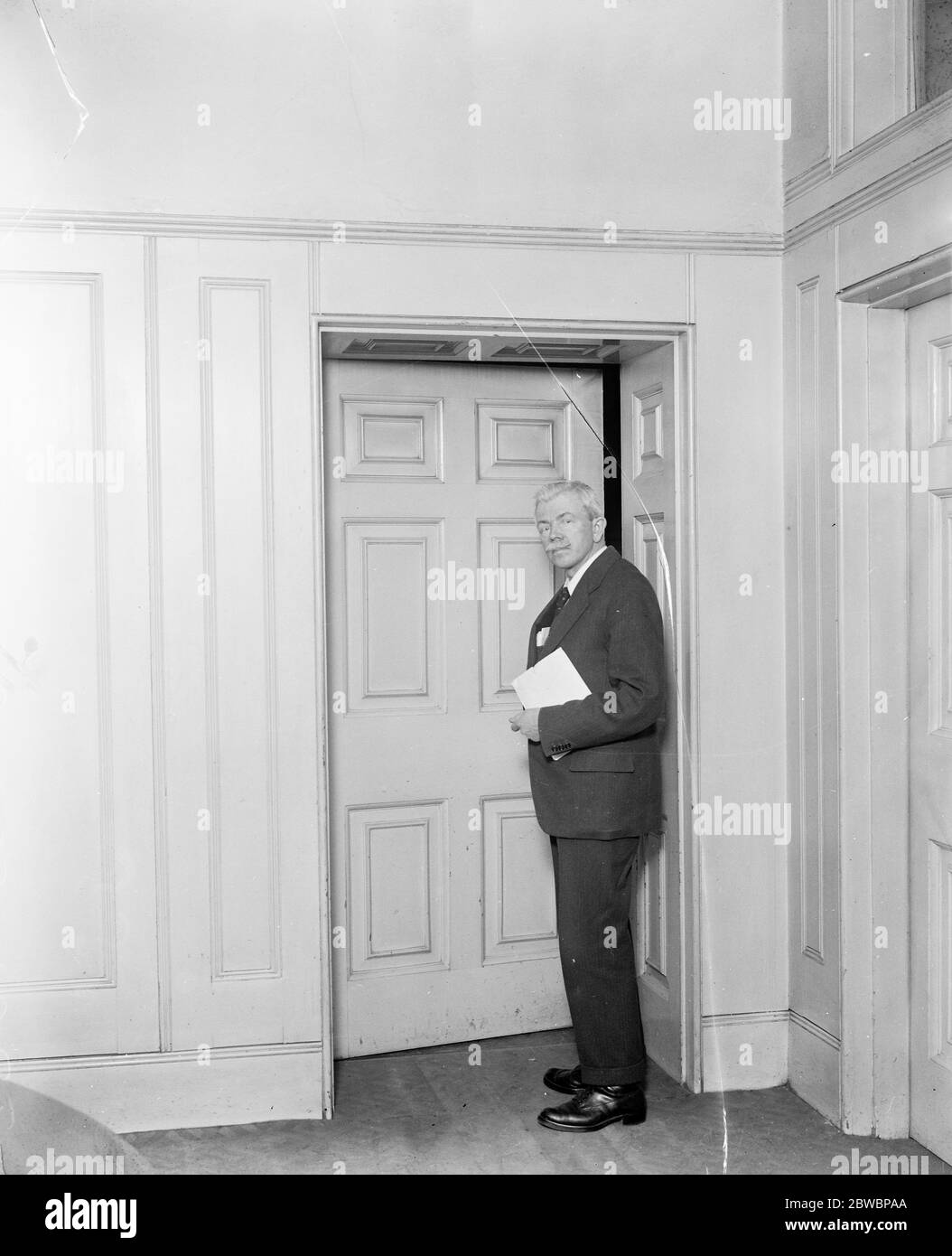 The deputy leader of the House and the  secret  door . Mrs J R Clynes , the deputy leader of the House , who has just moved into No 11 , Downing Street , his official residence , about to pass through the communicative door leading to No 10 Downing Street to see Mr Ramsay MacDonald , the Premier . 8 February 1924 Stock Photo