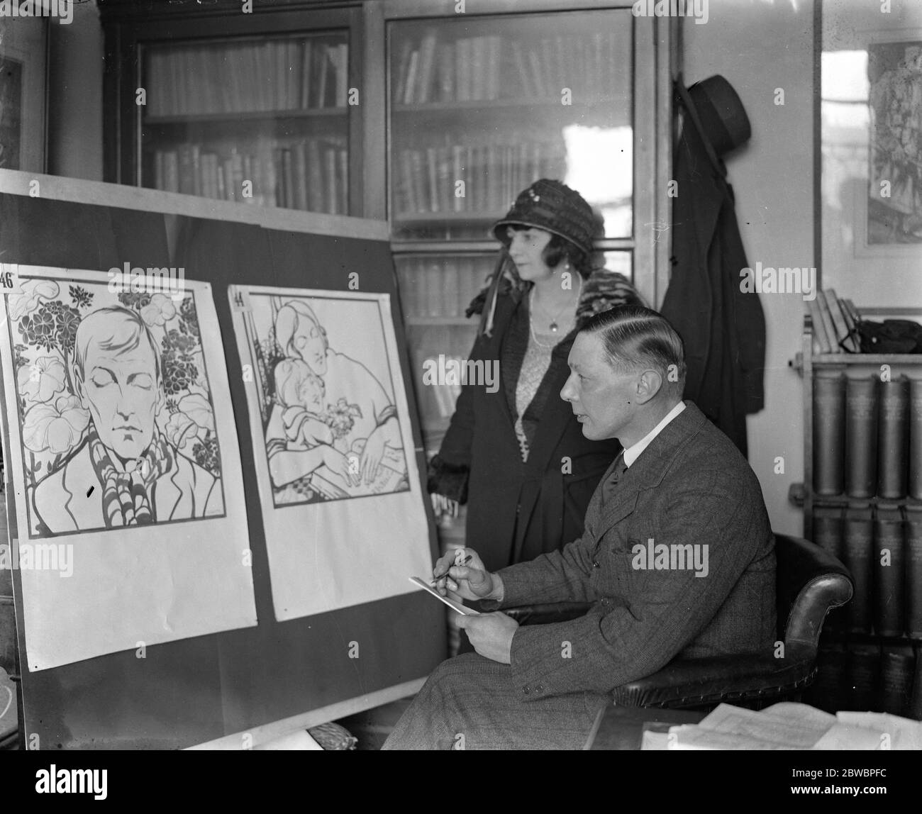 Mr G E Studdy and Mrs Studdy inspect winning poster for geranum day Mr G E Studdy ( of Bonzo fame ) and Mrs Studdy inspecting the poster design by Miss Maimie Firth which won the first prize in the second art students poster competition for the best design to advertise ; geranium day ' 17 March 1924 Stock Photo