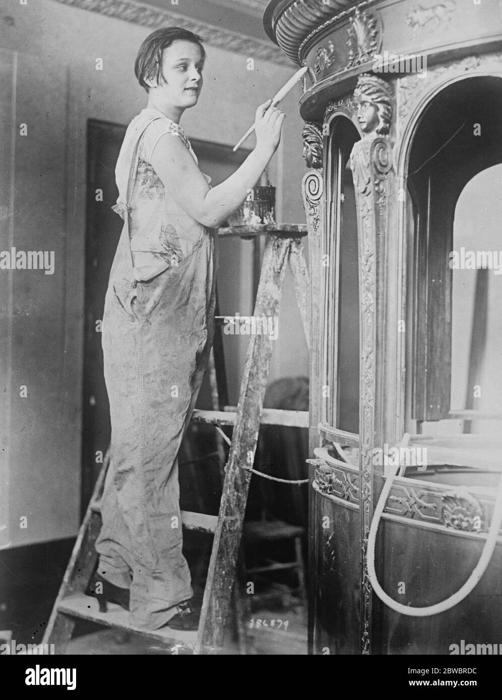 Gloria Gould Bishop as painter . Mrs Gloria Gould Bishop , youngest daughter of the late George Jay Gould , the American millionaire , re decorating the stalls of the New Embassy Theatre , New York , which she is to manage . 10 August 1925 Stock Photo
