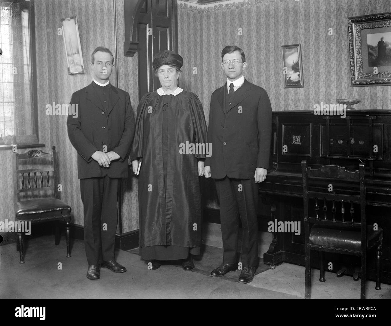 The only woman Bishop in the world arrives in London . Bishop Alma White , who is head of the Pillar of Fire church of America , has arrived in London . She is seen with her two sons , the Rev R B White ( right) and the Rev A E White ( left ). 26 November 1926 Stock Photo