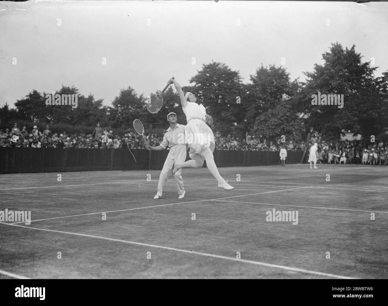 International tennis party at Roehampton club Miss E Colyer and P D B Spence in play 22 June 1925 Stock Photo