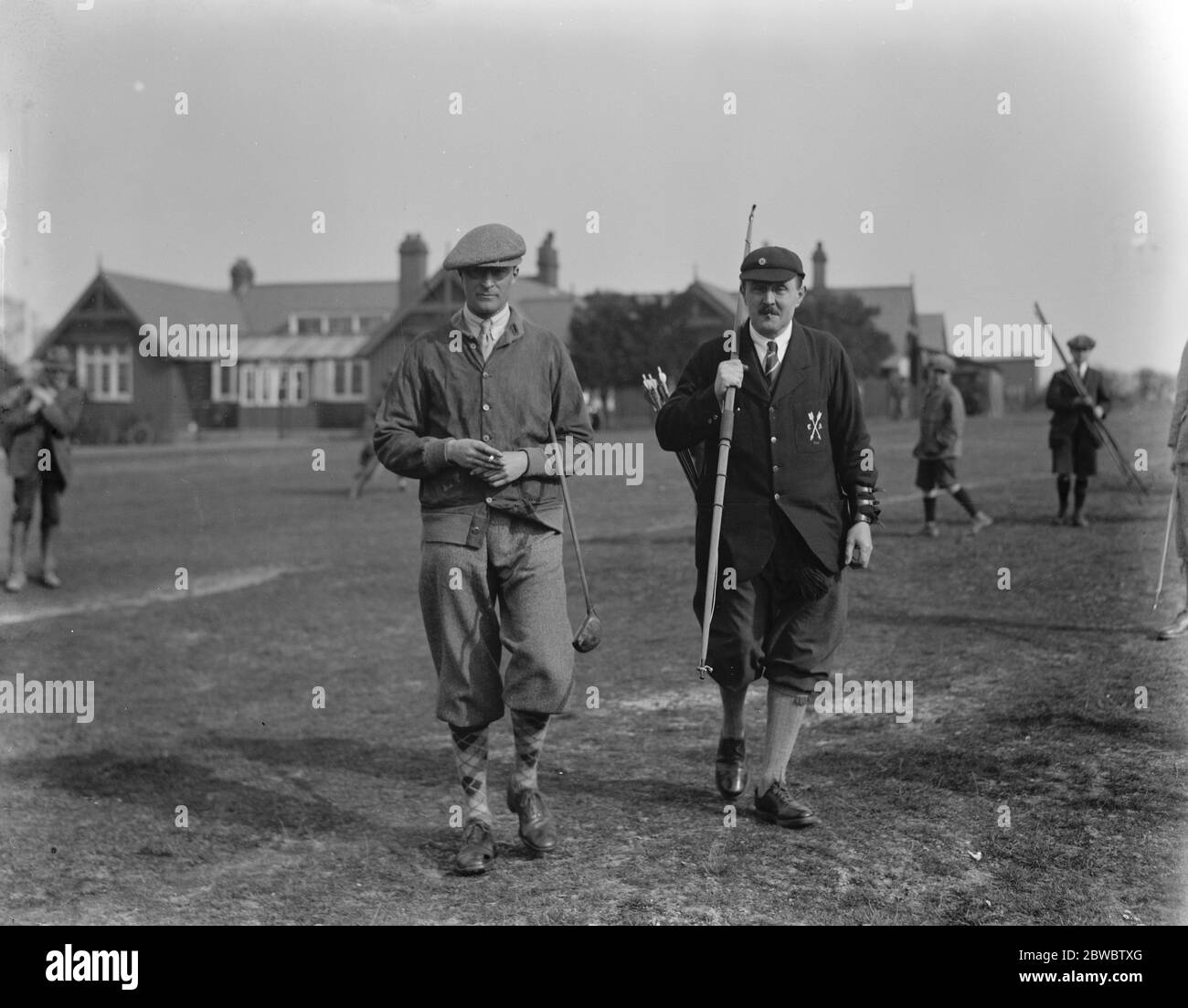 Golf : Ball versus arrow between Cambridge University and Royston Club at Royston . R S Momber , of Trinity College , Cambridge , Captain of the Archers and R H T Rowley , Captain of the golfers . 13 March 1926 Stock Photo