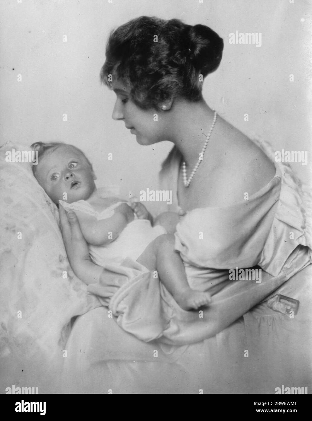 Baby boy of title exhibited at women ' s welfare centre . Baroness Ella Pollak von Parnegg with her little son , the Baron Alexander , who was shown as a good specimen of ' the hundread per cent baby ' 13 August 1926 Stock Photo