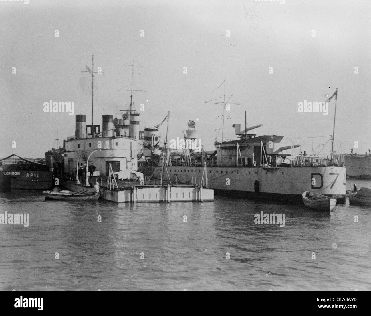 British warships on their way to China . HMS Ladybird , river gunboat , moored alongside her escort , the destroyer , Wanderer , in front of the Navy House , Port Said , on the way to China . 28 February 1927 Stock Photo