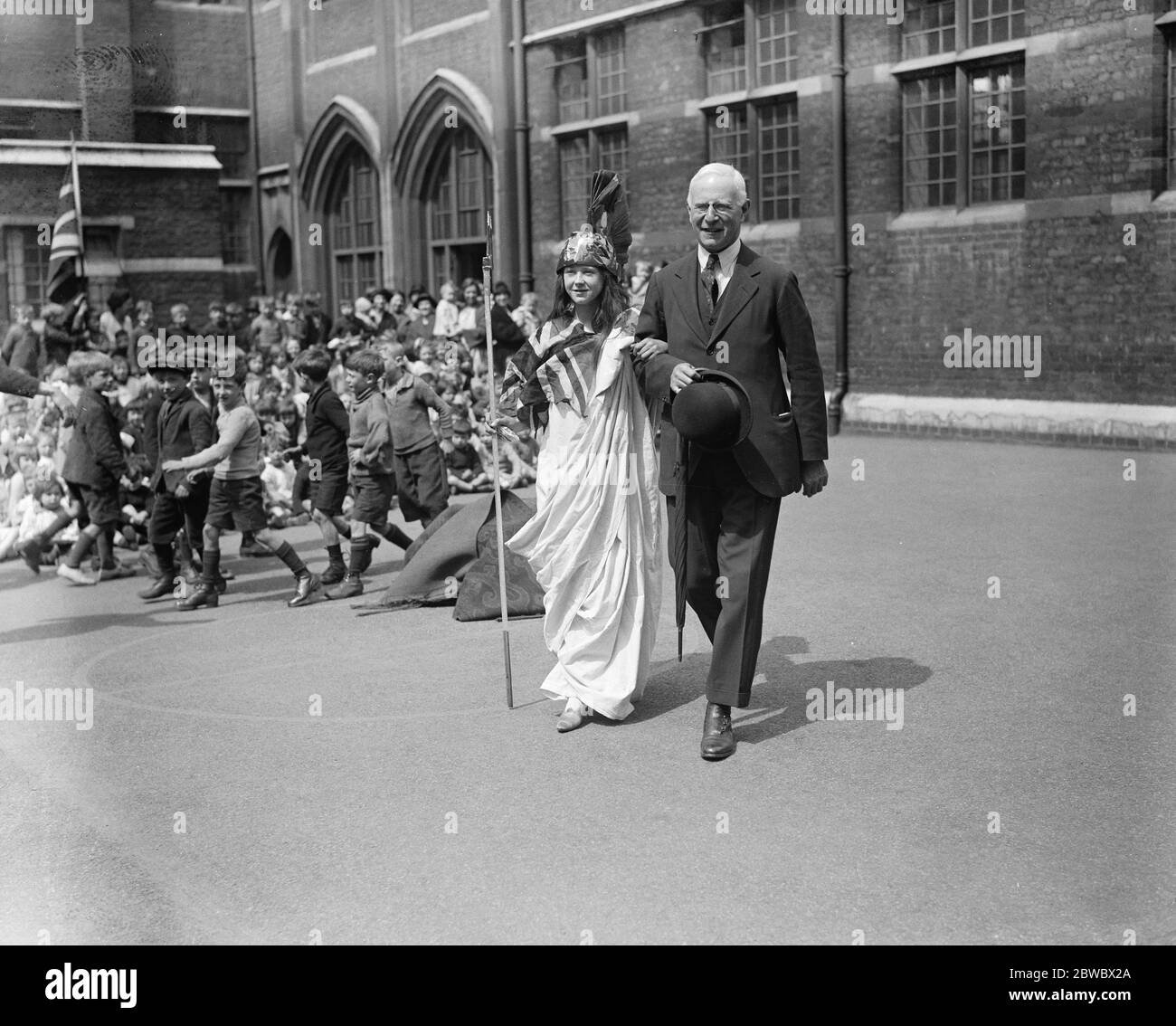 Empire Day celebrations at Turin street school , Bethnal Green Mr Percy Harris , the local M P , strolling with Britannia 22 May 1925 Stock Photo