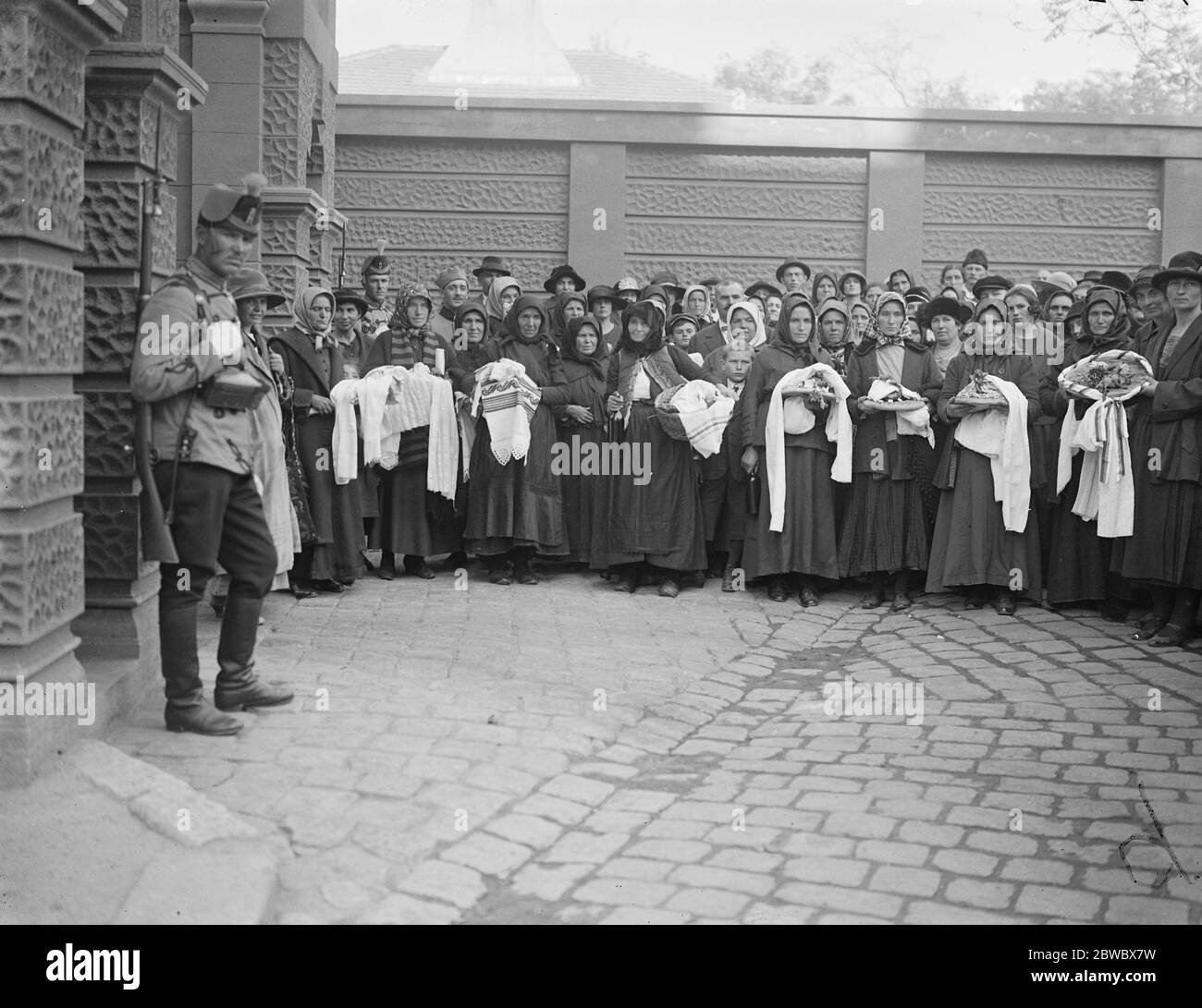 The future King of Serbia christened . Peasant women waiting at the gates of the Palace . They brought gifts of cooked fowl , meats , bread and lace for the infant Crown Prince . 24 October 1923 Stock Photo