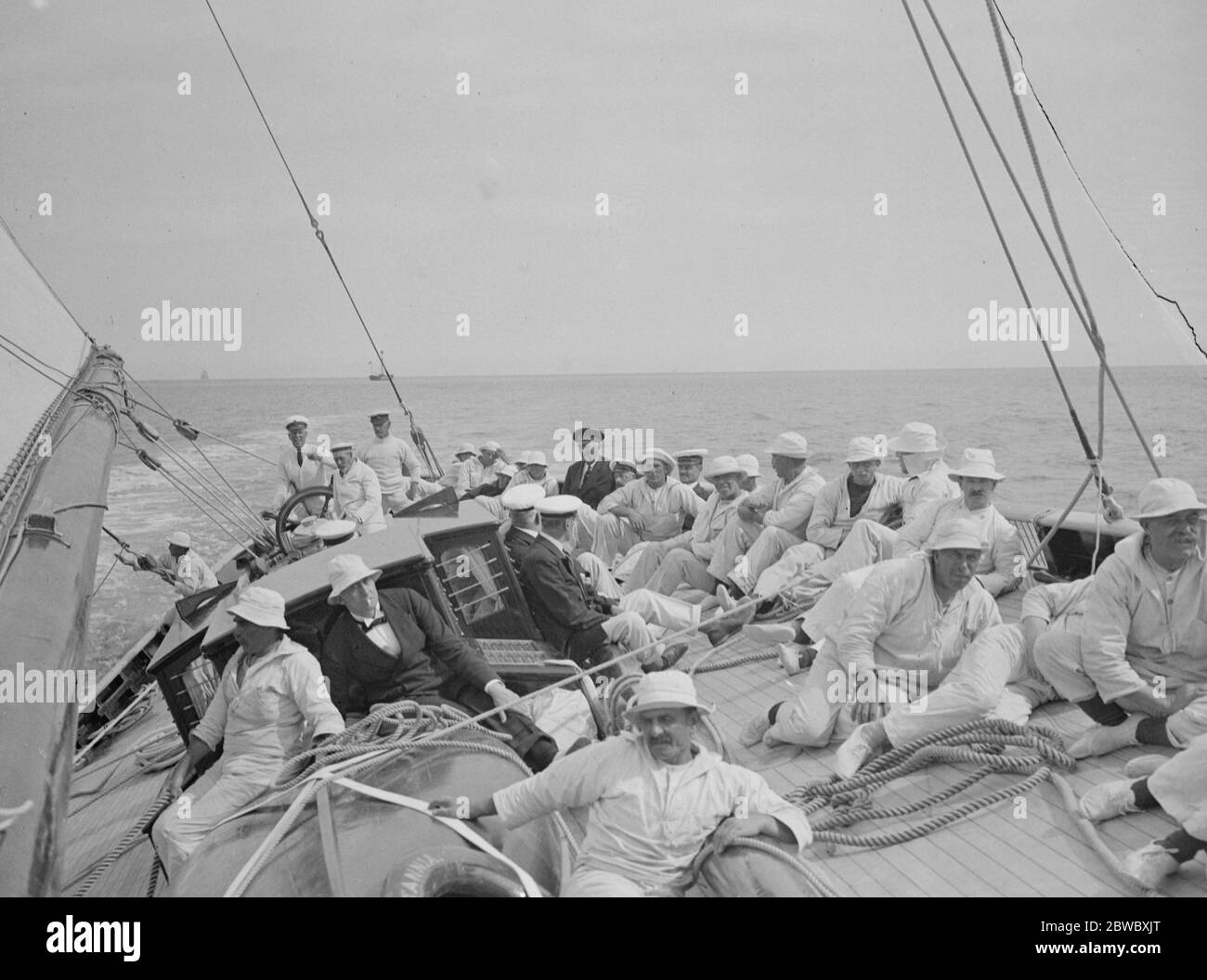 The King takes the wheel of his yacht  Britannia . Making a fine run , a photo taken from the main mast . The King is seen next to Maj P Hunloke , who at the time the picture was taken had charge of the wheel . 7 August 1924 Stock Photo