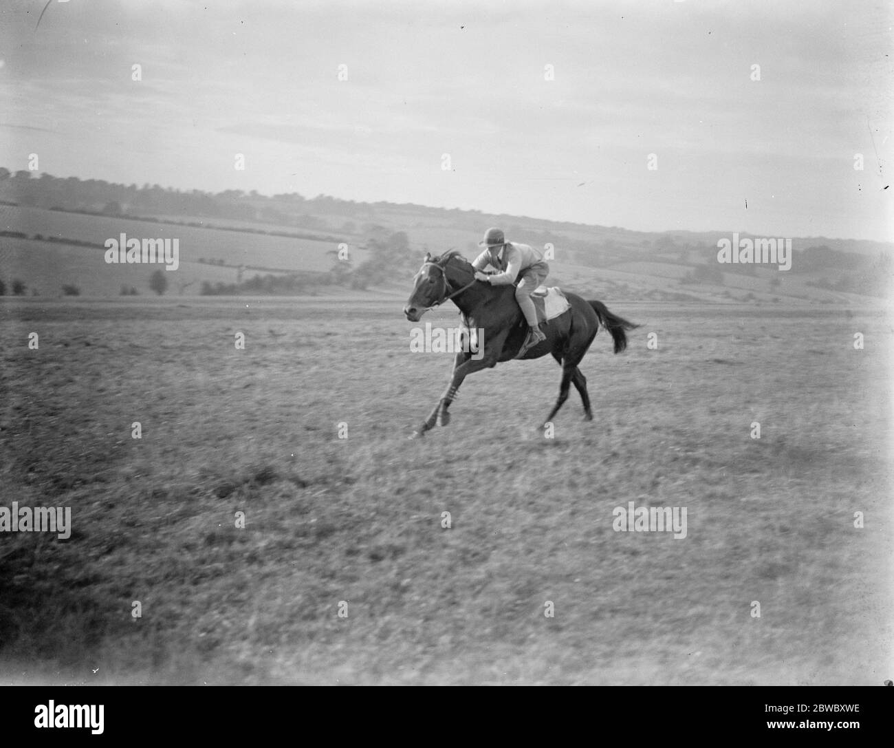 Our most wonderful girl rider : Mr W Nightingall says no light weight jockey could concede her 1 lb in a race . Miss Margery Nightingall going at full speed in a one mile gallop with stable lads on Epsom Downs . 16 October 1923 Stock Photo