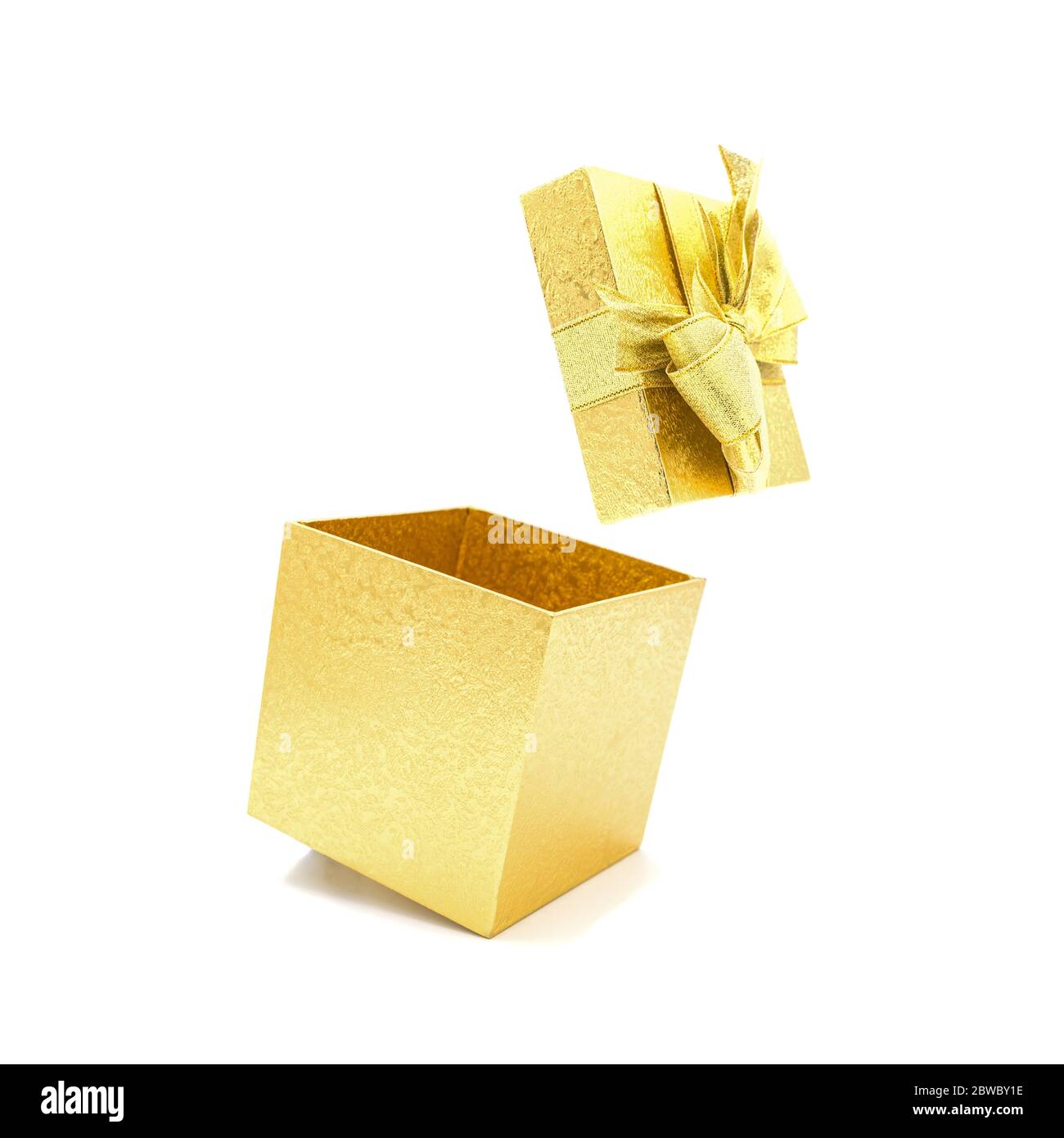 Open beautiful gold gift box with ribbon isolated on white background. Stock Photo
