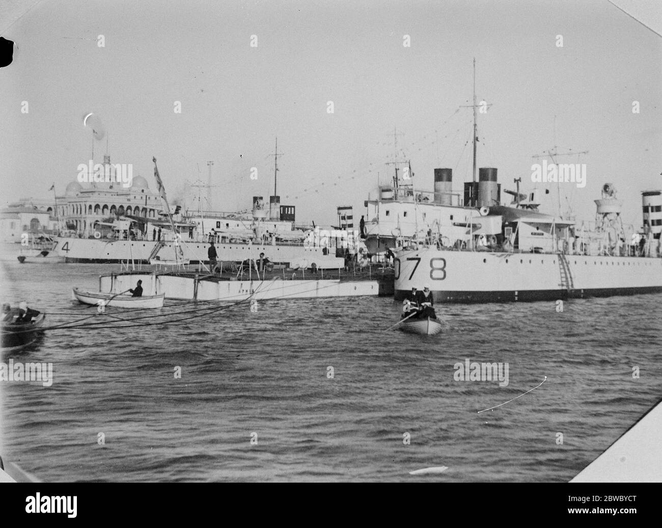 British warships on their way to China . HMS Aphis , river gunboat , alongside her escort , the destroyer Wolverine , at Port Said on the way to China . Behind her are the Ladybird and Wanderer , on their way to the Far East . 28 February 1927 Stock Photo