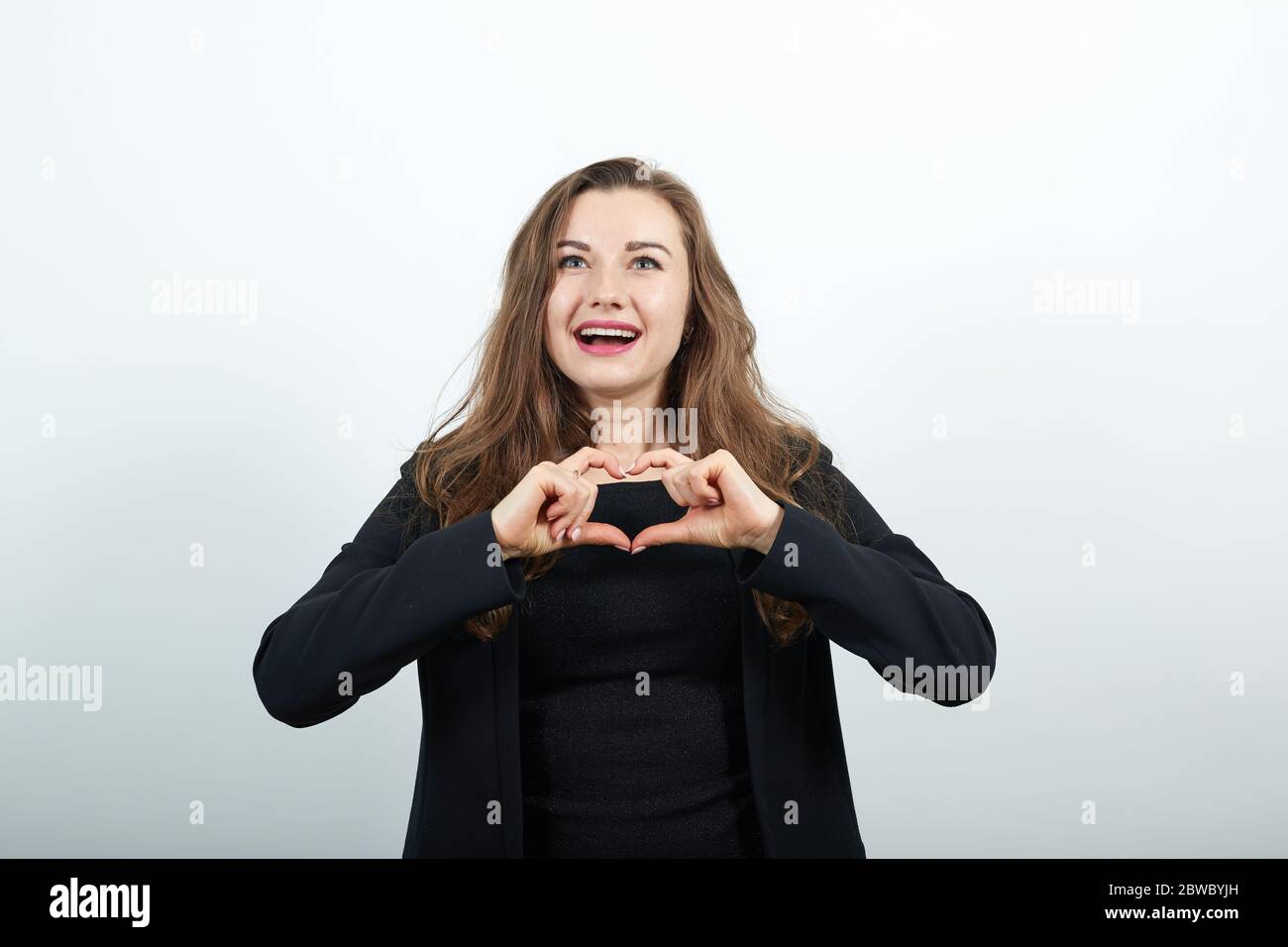 Happy Female Smiles, Makes A Heart Shape With Her Hands. Love ...