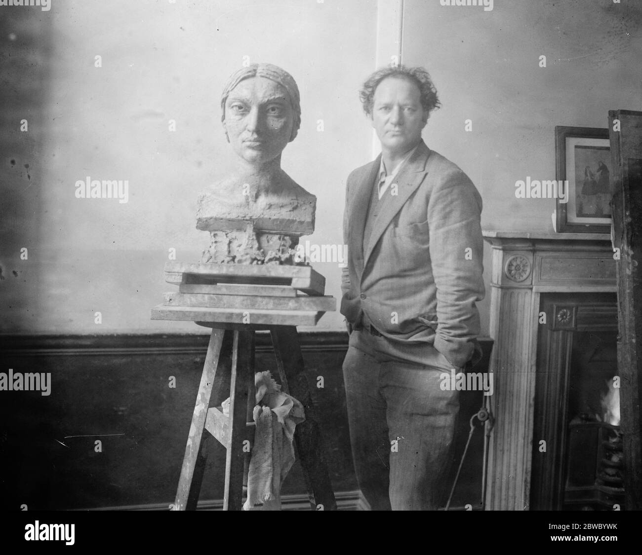 Sunita Devi , a beautiful Indian dancer , who is Epstein 's newest model . Epstein with the bust of Sunita Devi on which he is now working . 28 August 1925 Stock Photo
