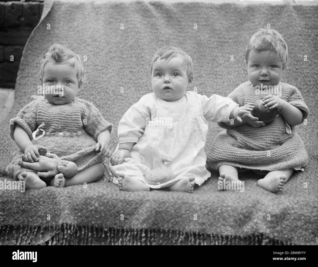 Bow triplets awarded consolation prize in Empire Baby Competition . A consolation prize of a Dunkley Safety pram was awarded to ( left to right ) Patrick , Sheila , and Dennis Girton , triplets , of Bow , London , in the Empire Baby Competition organised by the National Baby Week Council . 29 July 1924 Stock Photo