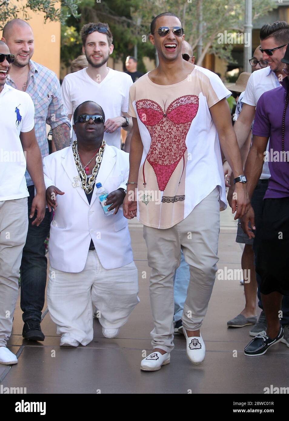 Marvin Humes of JLS is handcuffed to a dwarf named 5Cent on his stag do in Las Vegas, Nevada with fellow bandmates Oritise, Aston and JB. The group hit various casinos including the Bellagio, Ceasars and The Venetian. 2 May 2012 Stock Photo