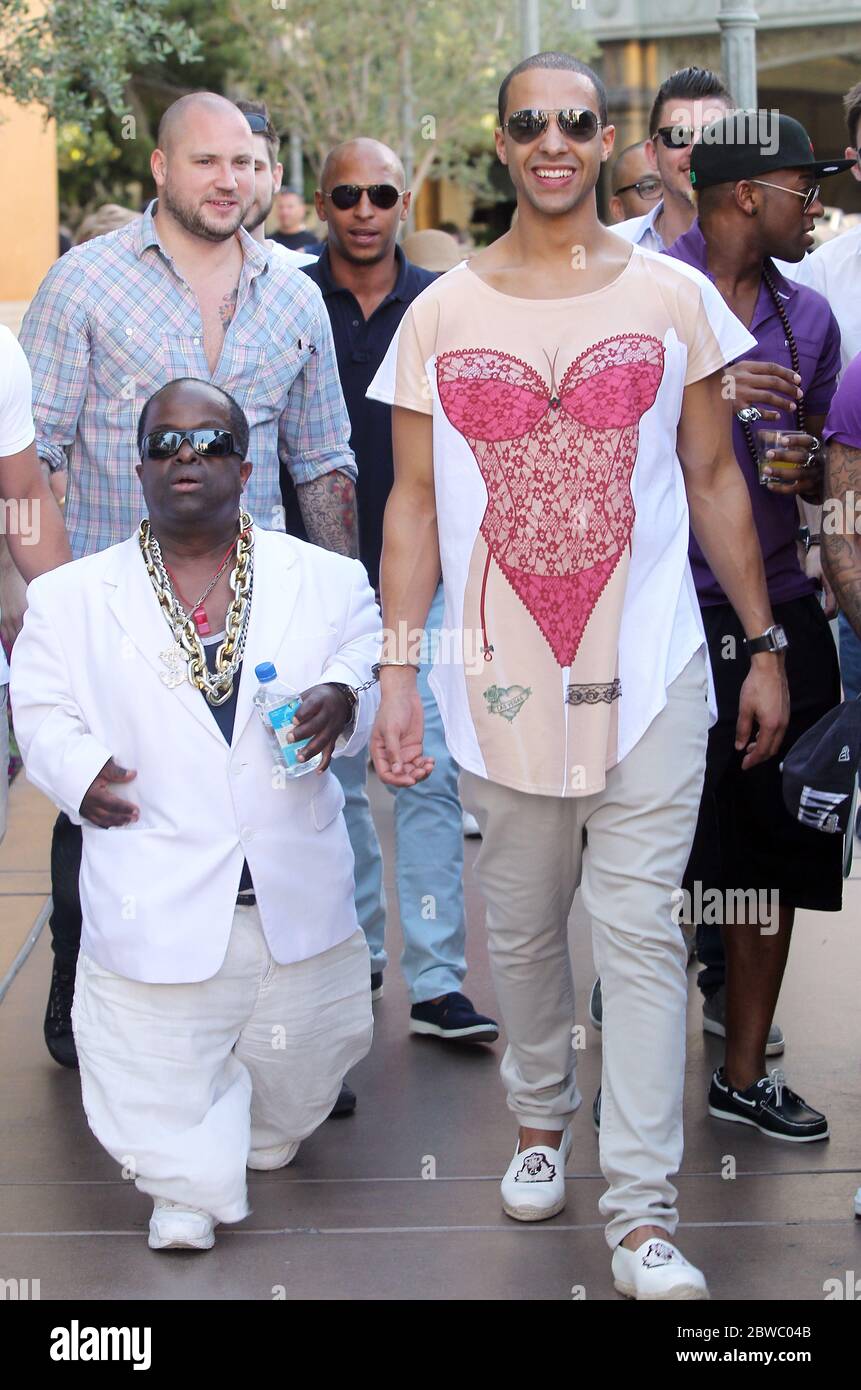 Marvin Humes of JLS is handcuffed to a dwarf named 5Cent on his stag do in Las Vegas, Nevada with fellow bandmates Oritise, Aston and JB. The group hit various casinos including the Bellagio, Ceasars and The Venetian. 2 May 2012 Stock Photo
