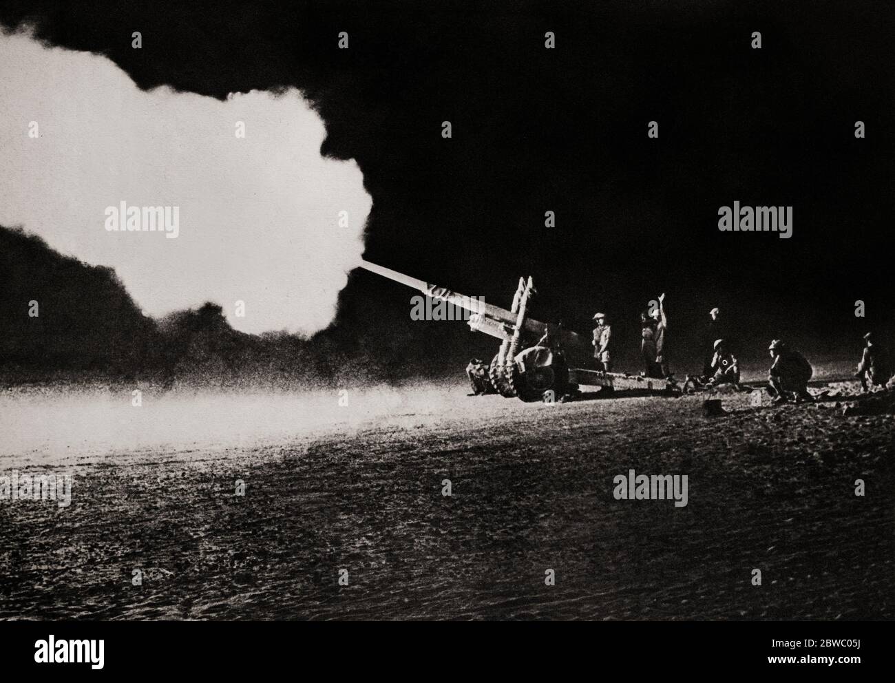 The 4.5 inch field gun bombarding enemy (German) tanks during the Second Battle of El Alamein (23 October – 11 November 1942) which prevented the Axis from advancing further into Egypt. It was a good weapon that could fire a 25 kg  shell up to 11.6 miles matching German 10.5 cm and 150 mm howitzers in range and firepower. Stock Photo
