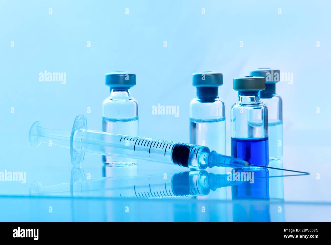 Close-up medical syringe with a vaccine. Vaccination and healtcare concept. Stock Photo