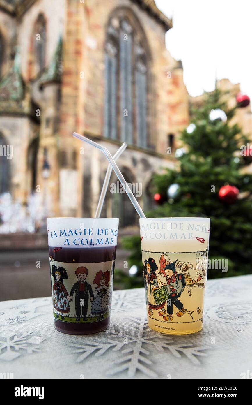 Colmar, Alsace, France - December 13, 2019: Two glasses of mulled wine on the background of the Catholic Cathedral . Stock Photo