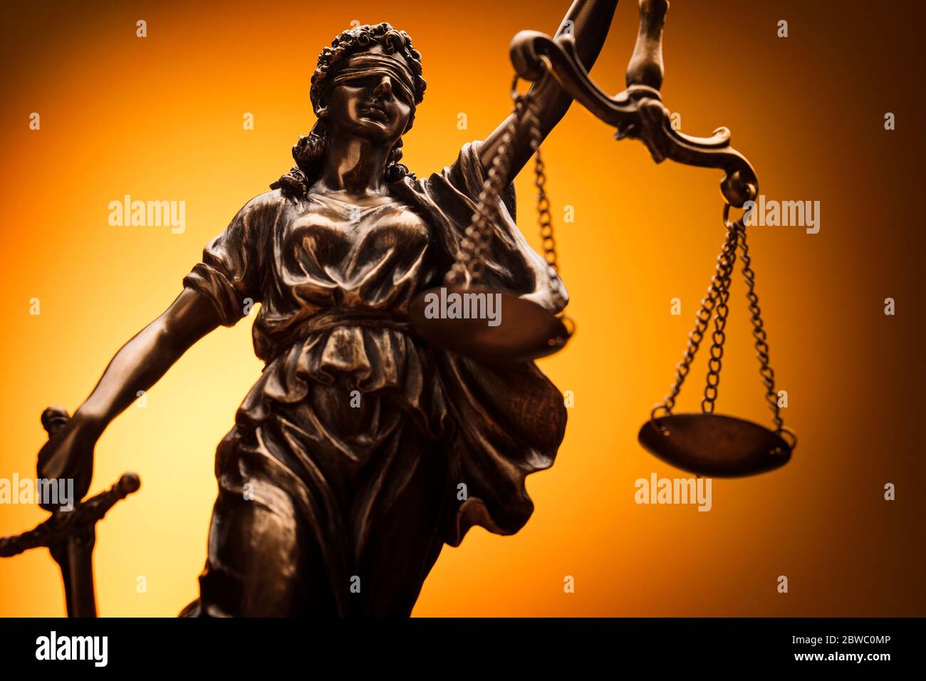 Close up on the figure of Justice with scales, sword and blindfold in a