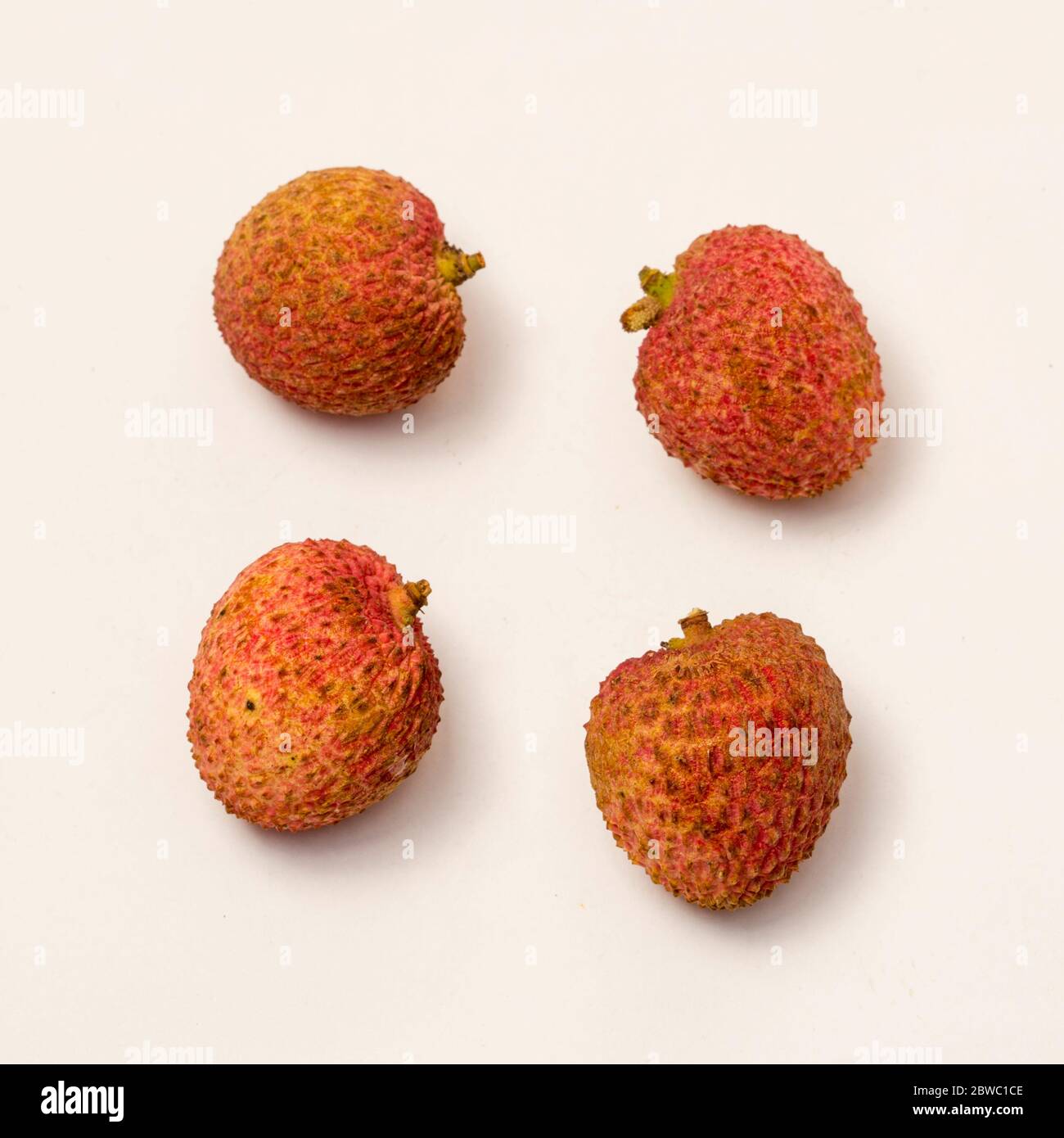 Close-up view of ripe lychee on white background. Stock Photo