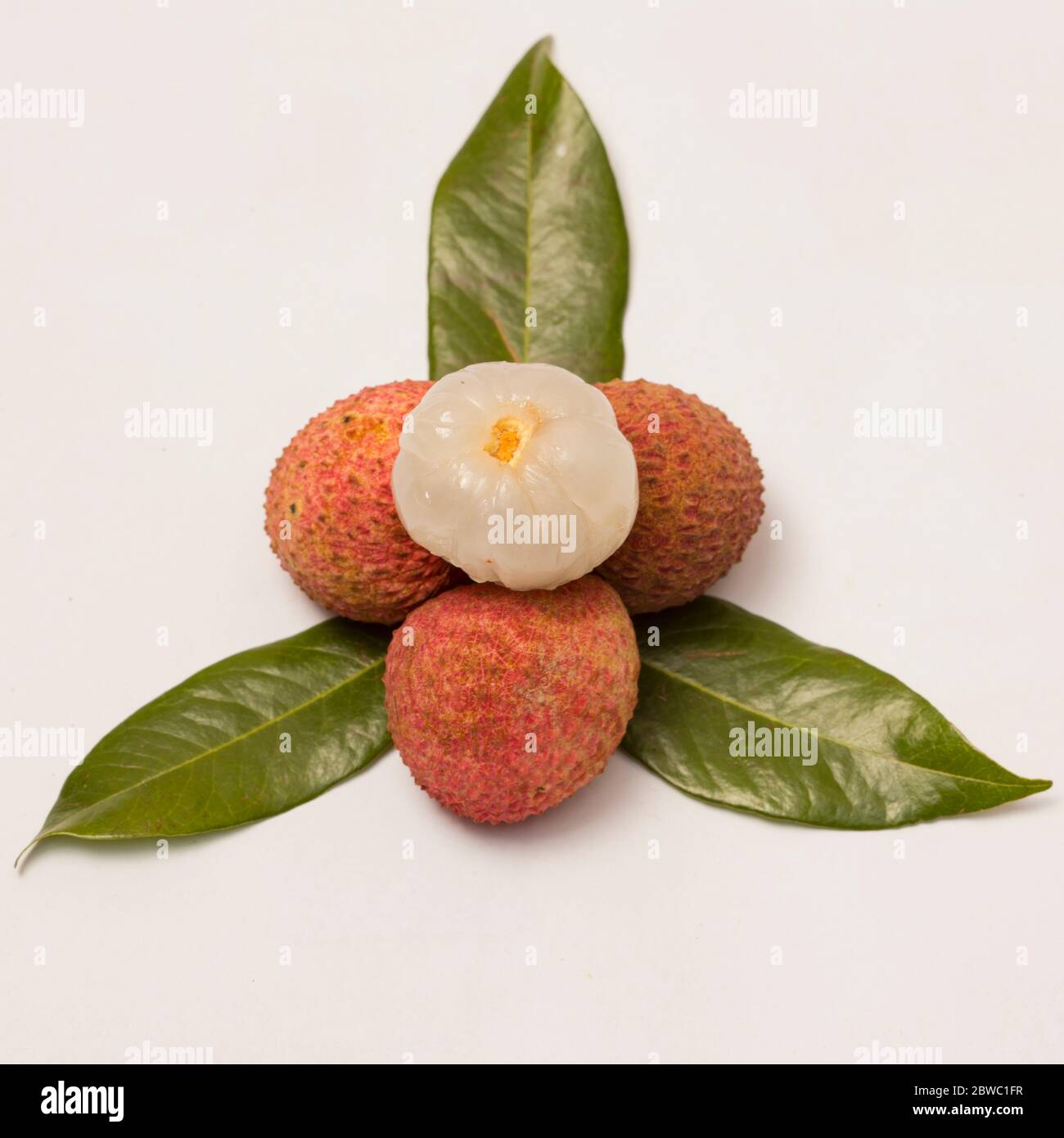 Close-up view of ripe lychee on white background. Stock Photo