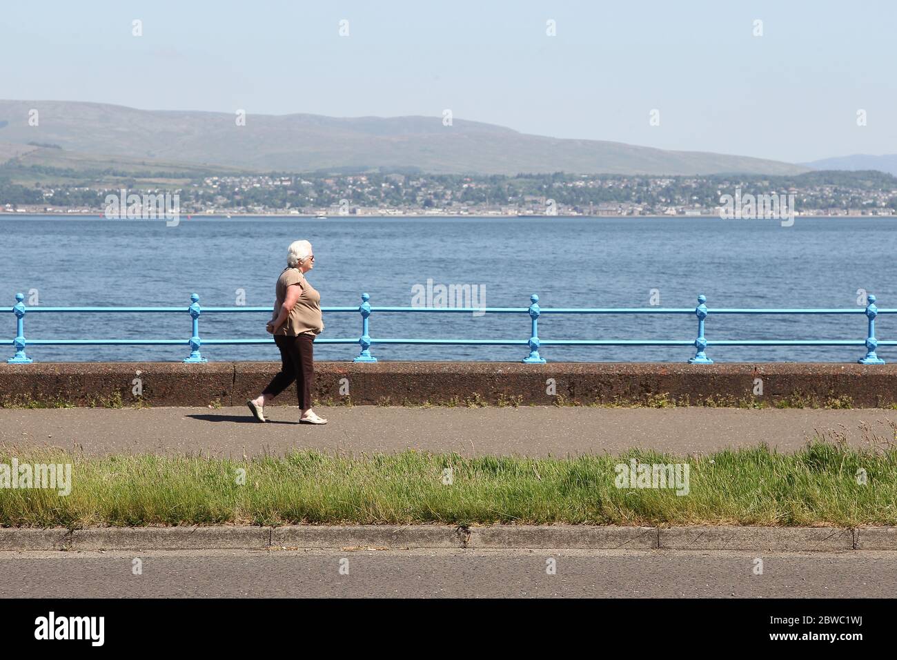 Esplanade Greenock, UK. 31st May, 2020. Locals enjoying the continuing good weather while observing good social distancing. Overlooking the Firth of Clyde towards Helensburgh. Credit: ALAN OLIVER/Alamy Live News Stock Photo