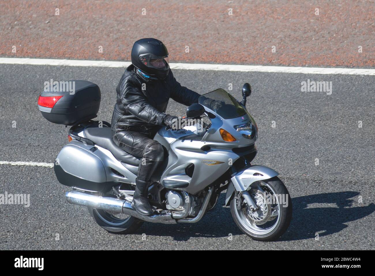 Honda Deauville; Motorbike rider; two wheeled transport, motorcycles,  vehicle, roads, motorbikes, bike riders motoring on the M6 motorway  Chorley, UK Stock Photo - Alamy