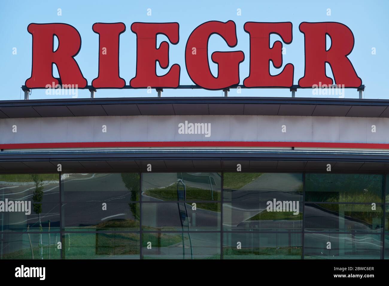 Göppingen, Germany - May 21, 2020: Möbel ( furniture ) Rieger, Facade with large red letters, the beautiful surroundings are reflected in the glass fr Stock Photo