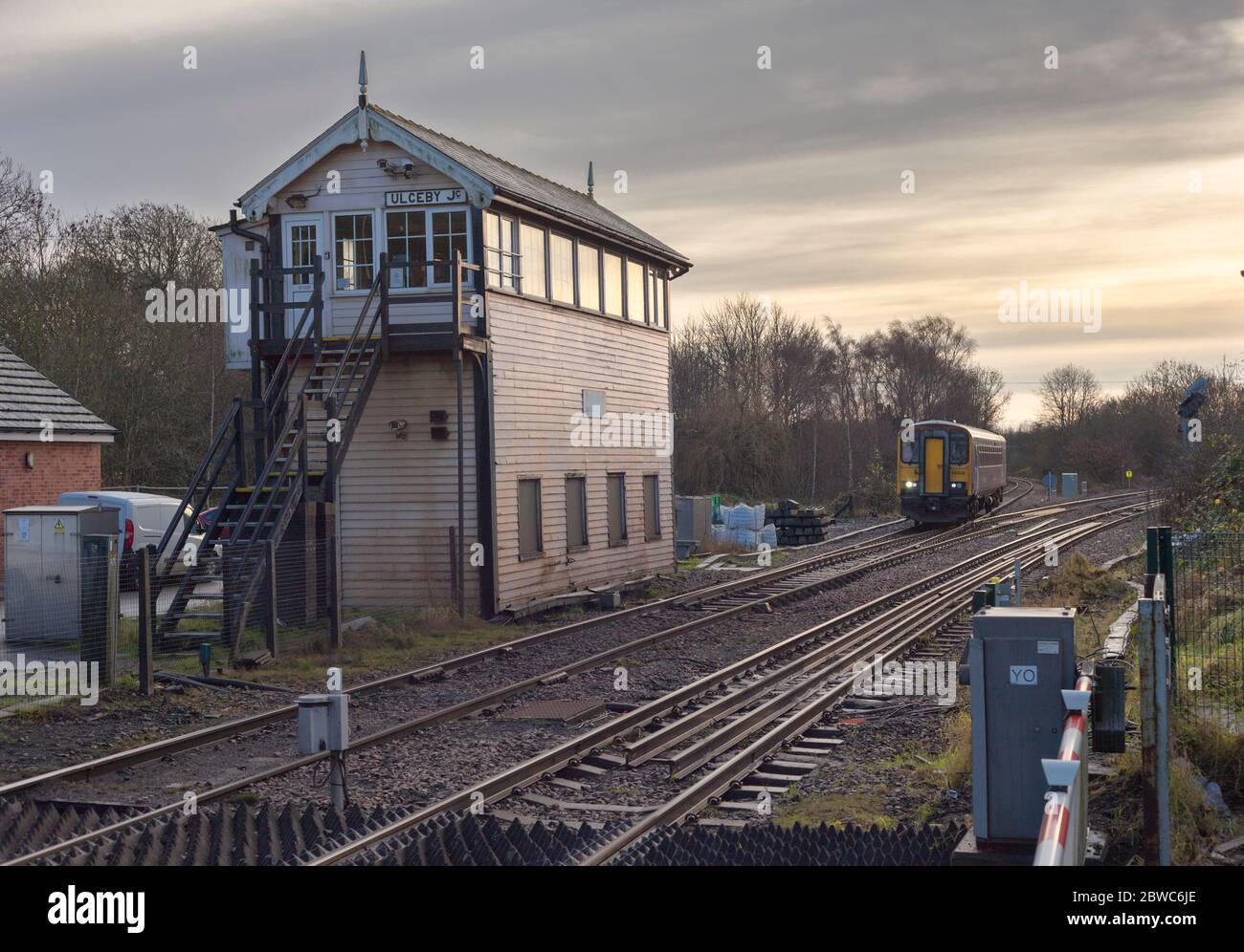 Northern rail class 153 single carriage train 153332 passing the large mechanical signal box at Ulceby, Lincolnshire Stock Photo