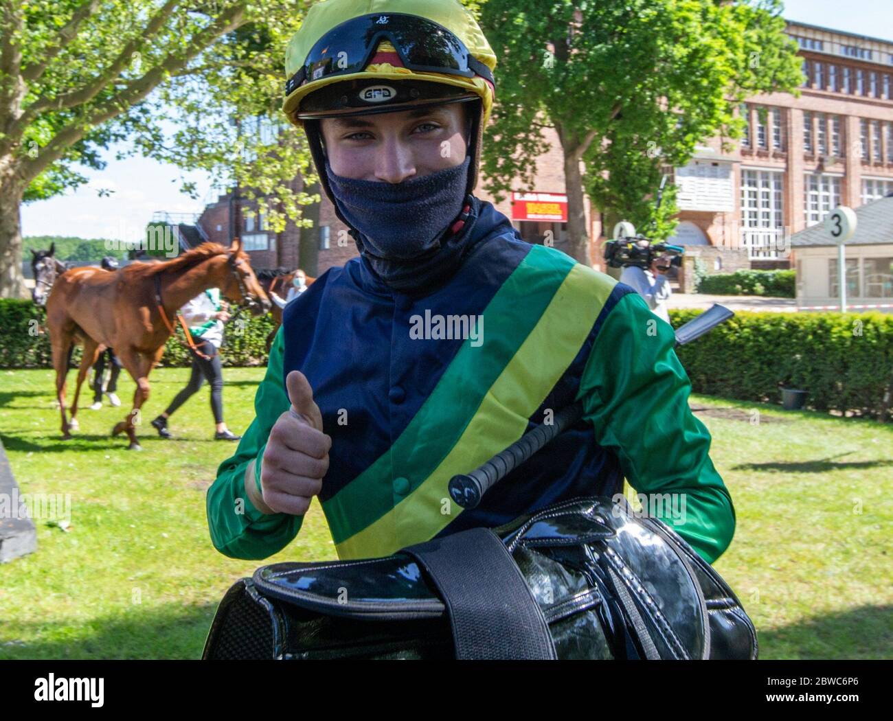 Hoppegarten, Germany. 31st May, 2020. Horse racing: Gallop, Hoppegarten Racetrack, second day of racing. Jockey Clement Lecoeuvre gestures laughing after the victory at the Gestüt Röttgen Diana-Trial group race. Due to the coronavirus pandemic, the races are held without spectators. Credit: Andreas Gora/dpa/Alamy Live News Stock Photo