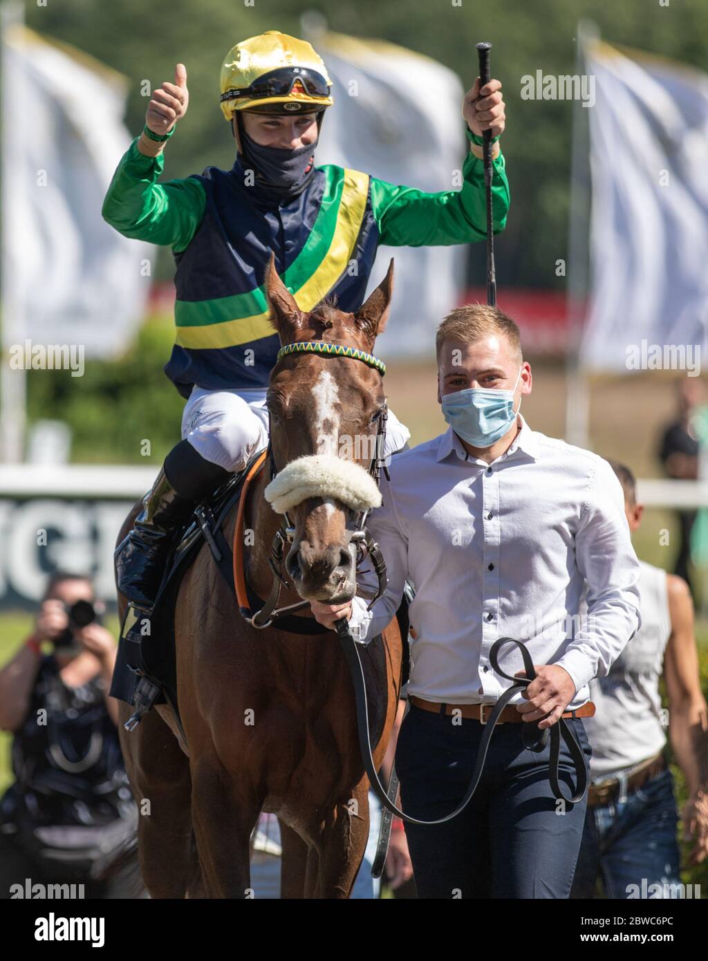 Hoppegarten, Germany. 31st May, 2020. Horse racing: Gallop, Hoppegarten Racetrack, second day of racing. Jockey Clement Lecoeuvre (l) wins on Kalifornia Queen from the stable Torjäger at Gestüt Röttgen Diana-Trial group race. Due to the coronavirus pandemic, the races are held without spectators. Credit: Andreas Gora/dpa/Alamy Live News Stock Photo