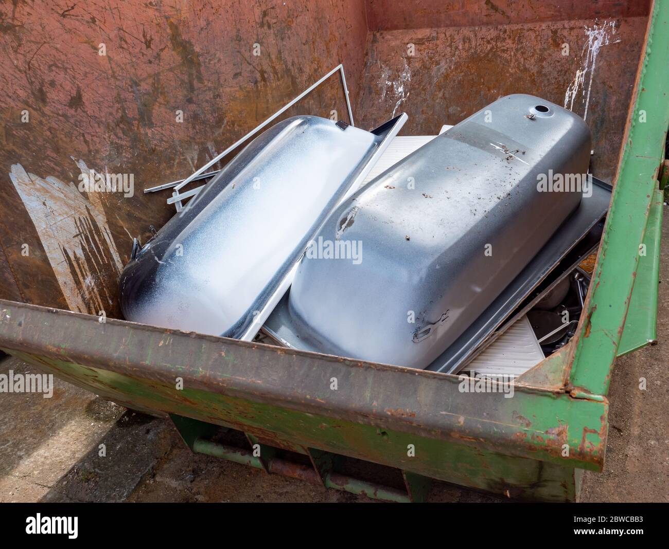 Containers with scrap iron bathtubs Stock Photo