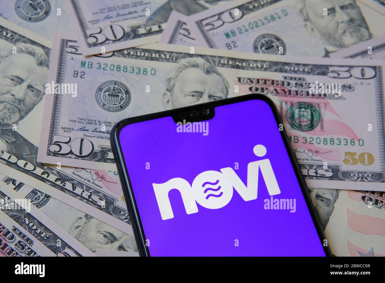 Stone /United Kingdom - May 28 2020: Novi logo on the smartphone placed on dollar banknotes. Novi is a new name for Facebook Calibra digital wallet us Stock Photo