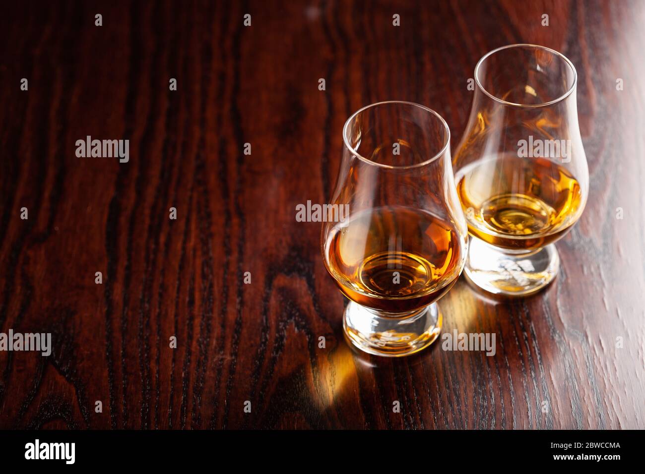 glass of whisky spirit brandy on dark brown background Stock Photo