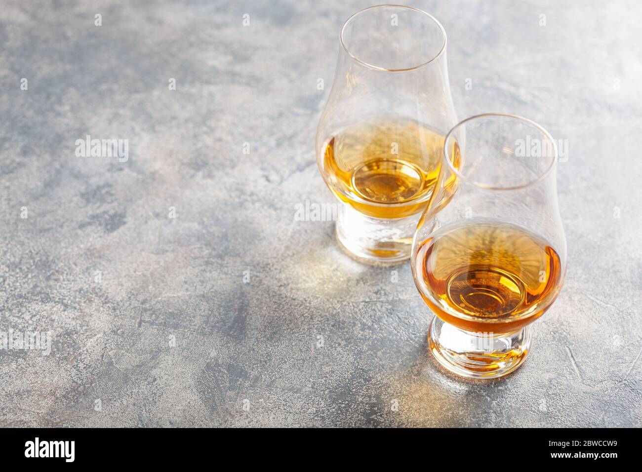 glass of whisky spirit brandy on gray concrete background Stock Photo