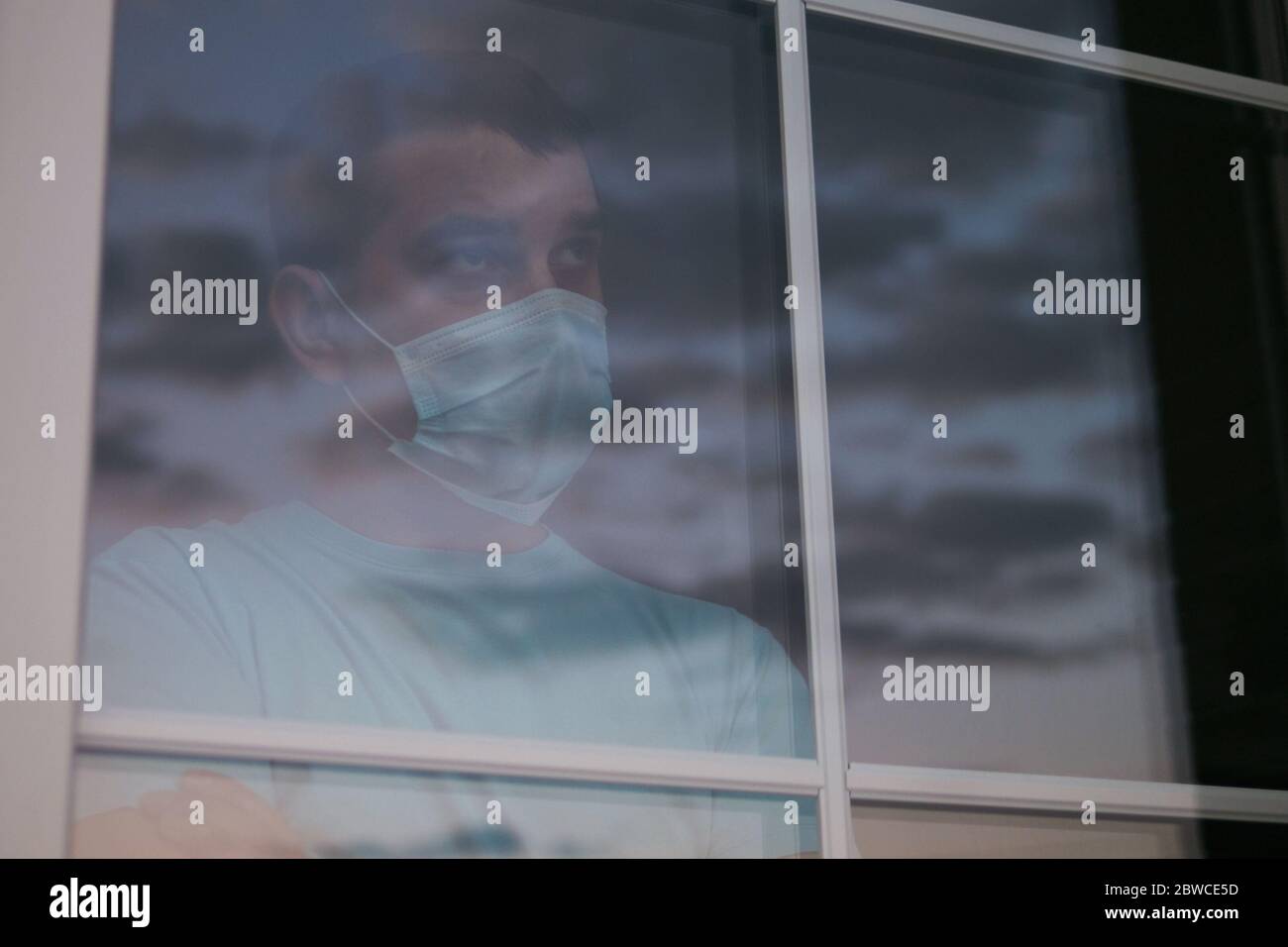 Portrait of a sad young man in a medical mask Stock Photo - Alamy