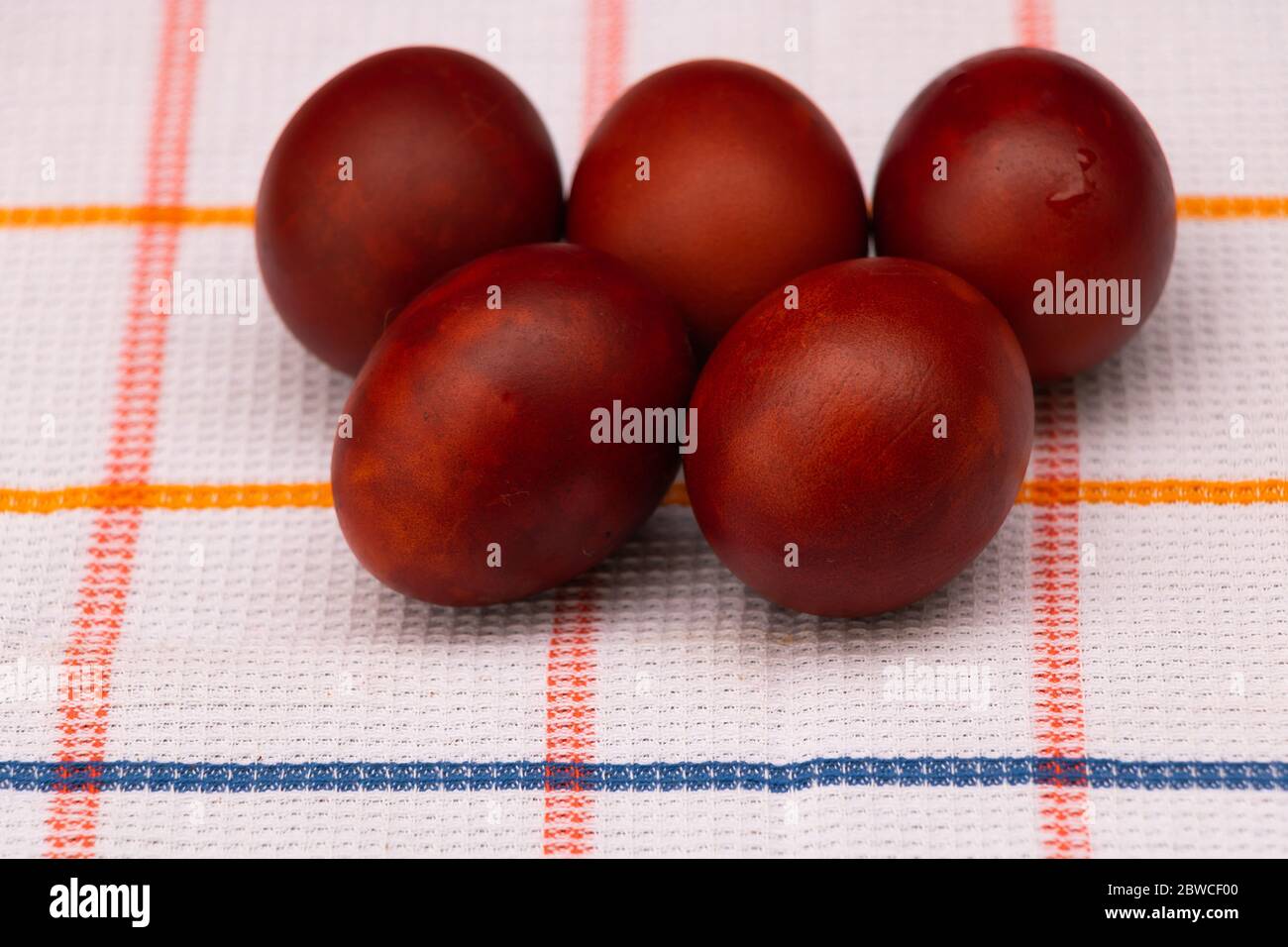Red eggs painted with natural onion peels Easter concept Stock Photo