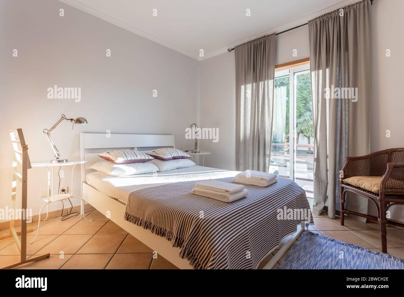 Modern bedroom with a large window. European hotel design. Stock Photo