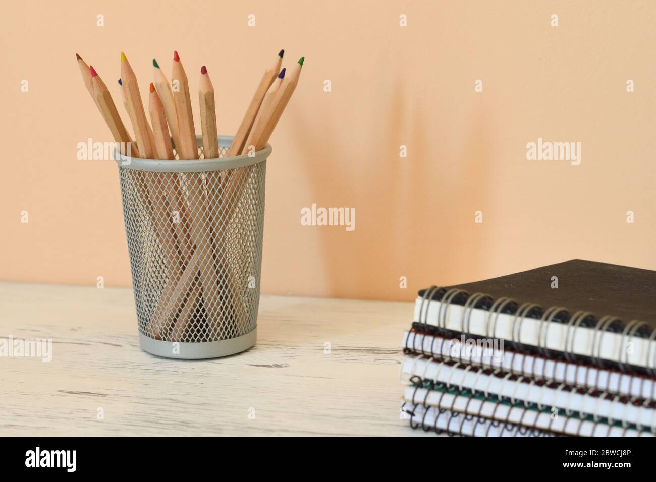 Pencil pot and a stack of notebooks Stock Photo