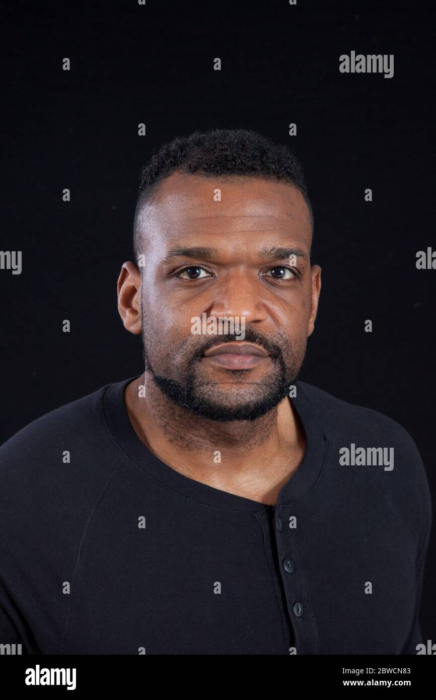 Pensive Black man in a black shrit Stock Photo - Alamy